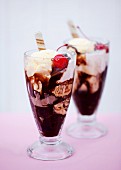 Chocolate and vanilla ice cream sundaes with cocktail cherries and wafer curls