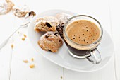 An espresso served with pine nut biscuits (Italy)
