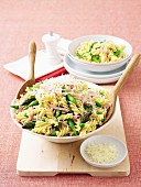 Pasta salad with ham, peas, green asparagus and parmesan