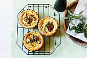 Puff pastry tartlets with onions, Camembert and sage