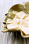 Dried garlic slices in a leaf-shaped dish