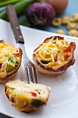 Savoury party snack wrapped in bacon with cheese on top