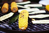 Corn cobs and courgettes on a barbecue