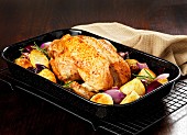 Roast chicken with potatoes and red onions