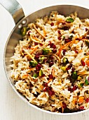 Pilau rice with pistachio nuts, pomegranate seeds and orange zest