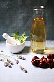 An arrangement of white wine, dried tomatoes, peppermint and lavender