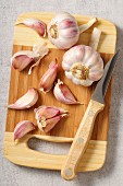 Garlic bulbs and garlic cloves on a chopping board