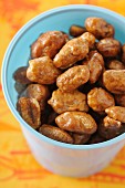 Roasted almonds in a light blue cup
