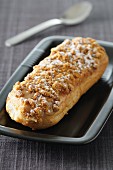 A gingerbread eclair dusted with icing sugar