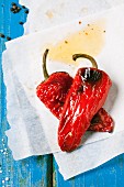 Grilled red peppers on baking paper (seen from above)