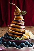 A pear and beetroot tower with grated cheese and blueberries