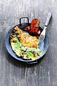 An omelette made with mushrooms and fried bacon