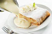 Apple and quark strudel with whipped cream and vanilla sauce
