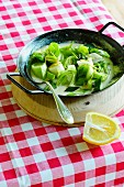 A leek medley in a black pan on a wooden board