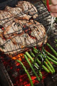 Lamb chops and asparagus on a barbecue