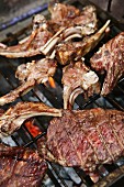 Lamb chops and steaks on a barbecue
