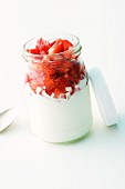 A jar of yogurt with marinated strawberries