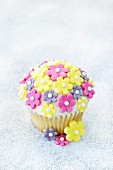A cupcake decorated with sugar flowers