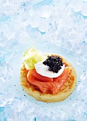 A blini topped with smoked salmon and caviar