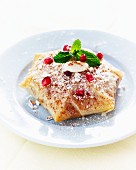 Pastilla with rabbit and pomegranate seeds
