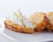 A slice of bread topped with cream cheese