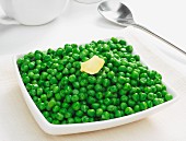 A bowl of peas with a knob of butter