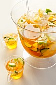 Apple and cucumber punch in a punchbowl and two glasses