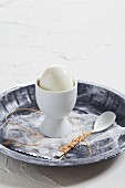 A hard-boiled egg in an egg cup