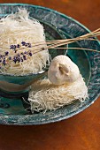 Rice noodles with lavender and garlic in a ceramic dish