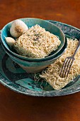 Mie noodles and garlic in a ceramic bowl