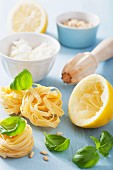 Ingredients for making tagliatelle with feta, lemons and basil