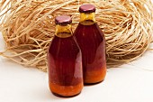 Two bottles of red palm oil