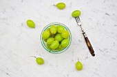 Green grapes in a glass on a marble surface