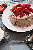 Chocolate pavlova cake with strawberries and cream