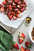 Strawberries sprinkled with brown sugar on a baking tray