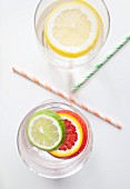 Citrus fruit slices in two glasses of water