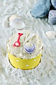 A cupcake decorated with a bucket and spade