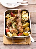 Roast chicken legs with apples in a roasting tin