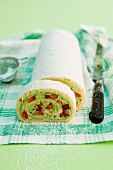 A sponge roll with a strawberry and basil cream filling