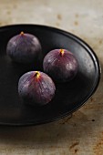 Three fresh figs on a plate