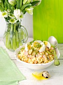 A vegetable salad with mayonnaise, ham and egg