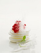 Meringues topped with redcurrants and sugar threads