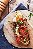 Tartine BLT with egg, bacon, tomato and rocket
