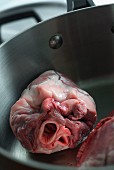 A raw lamb's heart in a saucepan