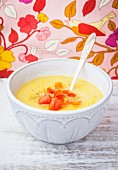 Cheddar cheese soup garnished with tomatoes