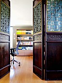 View into study through artistic, Oriental wooden door elements