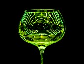 A green wine glass reflecting the light