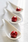 Three cherries on porcelain spoons