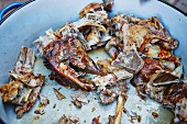 Leftovers of grilled lamb: head and bones