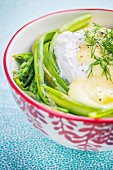 Asparagus strips with a poached egg, Hollandaise sauce and fresh dill
